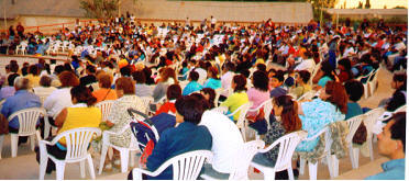 Gathering for the night service at amphitheater.