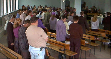 Students of seminar stand for prayer to have ears to hear, minds to receive and hearts to believe